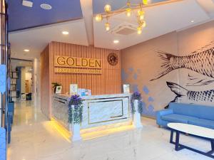 a lobby with a blue couch in a store at Golden Paradise Hotel - SHA PLUS in Karon Beach +88 photos