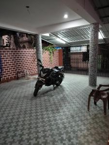 a motorcycle is parked in a parking lot at Hotel Panchvati in Durgāpur