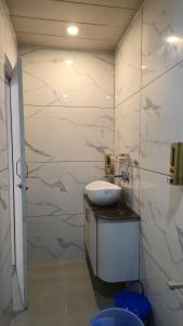 a bathroom with a sink and a toilet in it at Hotel Panchvati in Durgāpur