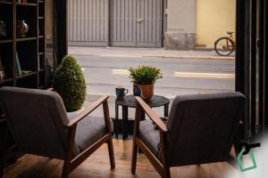 two chairs and a table with a plant on it at Hotiday Milano Risorgimento in Milan