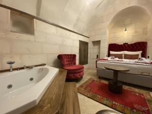 a large bathroom with a tub and a bed at Sevdalı Konakları in Avanos +72 photos