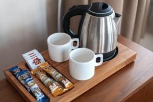 a table with a coffee pot and cups and cookies at Nan Hotel in Istanbul +6 photos