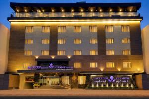 a hotel building with lights on the front of it at Lavender Premier in Bangalore