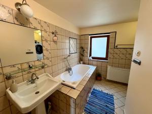a bathroom with two sinks and a bath tub at Ayur Garden Lanckorona in Lanckorona +154 photos