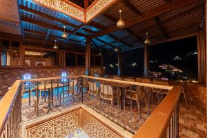 a balcony of a restaurant with chairs and a bar at Riad Seddiki in Chefchaouen