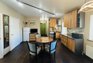 a kitchen and dining room with a table and chairs at Apart-Hotel IGORIVSKA in Kyiv