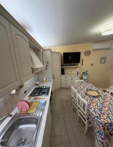 a small kitchen with a sink and a table at Casa Etna Soul in Paterno