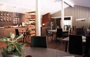 a dining room with tables and chairs and a restaurant at Haukeli Hotel in Haukeligrend
