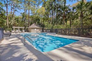 a swimming pool in a yard with a fence at DS1113: 1113 Duneside Drive in Kiawah Island