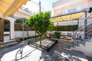 a tree in a courtyard of a building at Dream Houses Near Athens Airport By SEM in Artemida