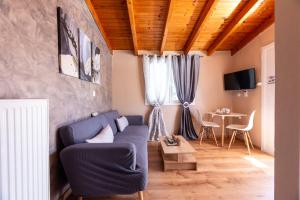 a living room with a blue couch and a table at Dream Houses Near Athens Airport By SEM in Artemida