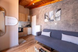 a living room with a blue couch and a kitchen at Dream Houses Near Athens Airport By SEM in Artemida