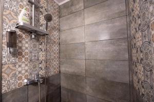 a shower stall in a bathroom with tiles on the wall at Dream Houses Near Athens Airport By SEM in Artemida +49 photos