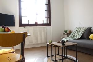 a living room with a couch and a table at Résidence du Loir - Le Petit Loft in Vendôme