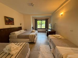 a hotel room with three beds and a window at Villa de Merlo All Inclusive & Spa by MH in Merlo +77 photos