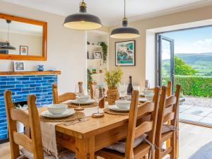 a dining room with a wooden table and chairs at Greenhill in Blackwaterfoot