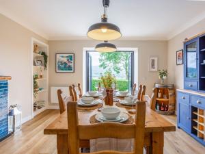 a dining room with a table and chairs at Greenhill in Blackwaterfoot +35 photos