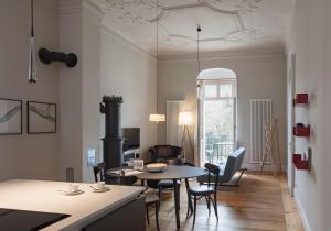 a living room with a table and chairs at Schloss Prossen in Bad Schandau
