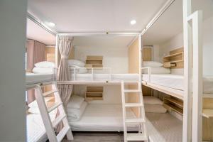 a room with four bunk beds in it at 2Re Hidden Hostel 58 Hàng Bạc in Hanoi