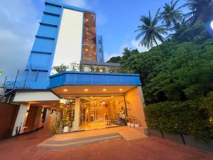 a building with a large tower on top of it at Golden Paradise Hotel - SHA PLUS in Karon Beach