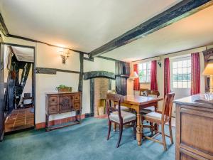 a dining room with a table and chairs at Glebe Cottage in Powick