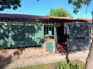 an old house with a gate in front of it at Las Gemelas in Rosario