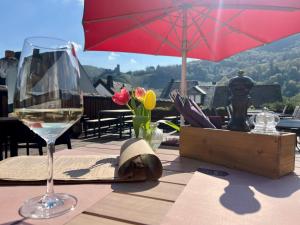 a glass of wine sitting on top of a table at Burgblickhotel in Bernkastel-Kues