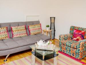 a living room with a couch and a coffee table at St Mary's Crescent House in Stanwell
