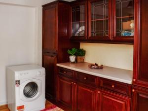 a kitchen with a washing machine in a kitchen at St Mary's Crescent House in Stanwell