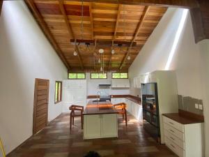 a kitchen with a table and chairs in a room at Boana Explora Pachijal in Pedro Vicente Maldonado