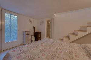 a bedroom with a bed and a staircase at Il Boschetto sul Mare - Goelba in Capoliveri