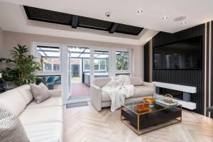 a living room with a white couch and a table at Riverside Villas in Manchester