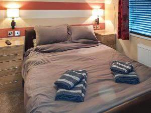 a bed with two pillows on it in a bedroom at Forrest Lodge in Plumbland