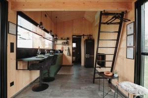 a kitchen with a ladder in a tiny house at Rusty Cabin -Tiny House in Neustift an der Lafnitz +12 photos