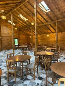 a dining room with tables and chairs in a building at Satul de vacanta Cuibul Lupilor in Ciucea
