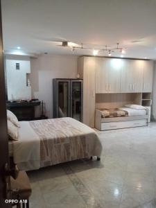 a large bedroom with two beds and a kitchen at Casa Eden in Ventimiglia