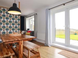 a dining room with a table and a large window at Trelowen in Wadebridge