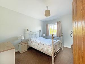 a bedroom with a bed and a window at Gelli Hir in Bronant
