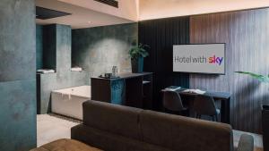 a bathroom with a tub and a table and a tv at Hotel PALAZZO PEPE & JACUZZI in Naples