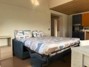 a bedroom with a bed in a room with a kitchen at casale dei cinque colli APPARTAMENTO in Ostra