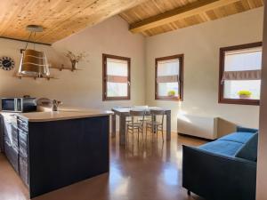 a kitchen and living room with a couch and a table at casale dei cinque colli APPARTAMENTO in Ostra
