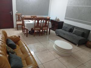 a living room with a couch and a table and chairs at Johannys'co in Abidjan +23 photos