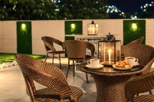 a patio with a table with chairs and a candle at Hotel LA Eden in Mussoorie +44 photos