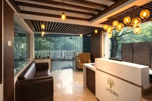 a lobby with a reception desk and a large window at Hotel LA Eden in Mussoorie