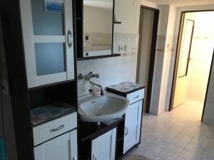 a bathroom with a white sink and a mirror at Roubenka Na vršku in Staré Křečany +29 photos
