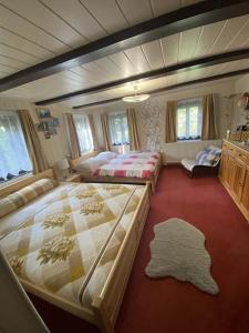 a large bedroom with two beds and a couch at Roubenka Na vršku in Staré Křečany