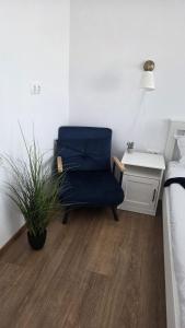 a blue chair sitting in a room with a desk at Zen Studio Olimp Poolside in Olimp