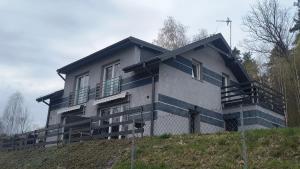 a house sitting on top of a hill at Domki Mała Tresna in Bierna