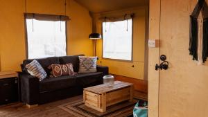 a living room with a couch and a table at The Camp at The Wave in Bristol