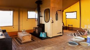a living room with yellow walls and a fireplace at The Camp at The Wave in Bristol